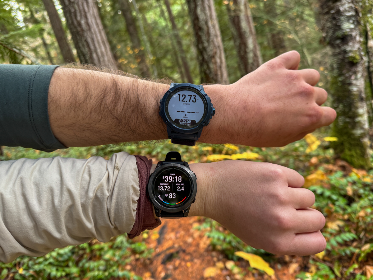 Two GPS watches side by side on wrists